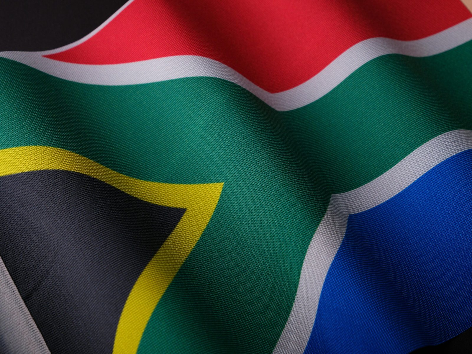 Close-up of a waving South African flag showcasing its vibrant colors and detailed texture.